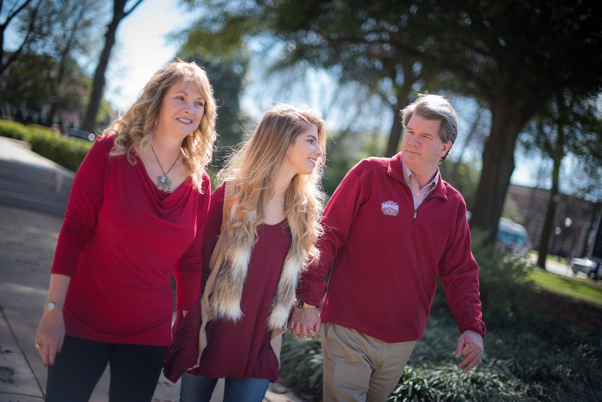 A family walks together on the quad